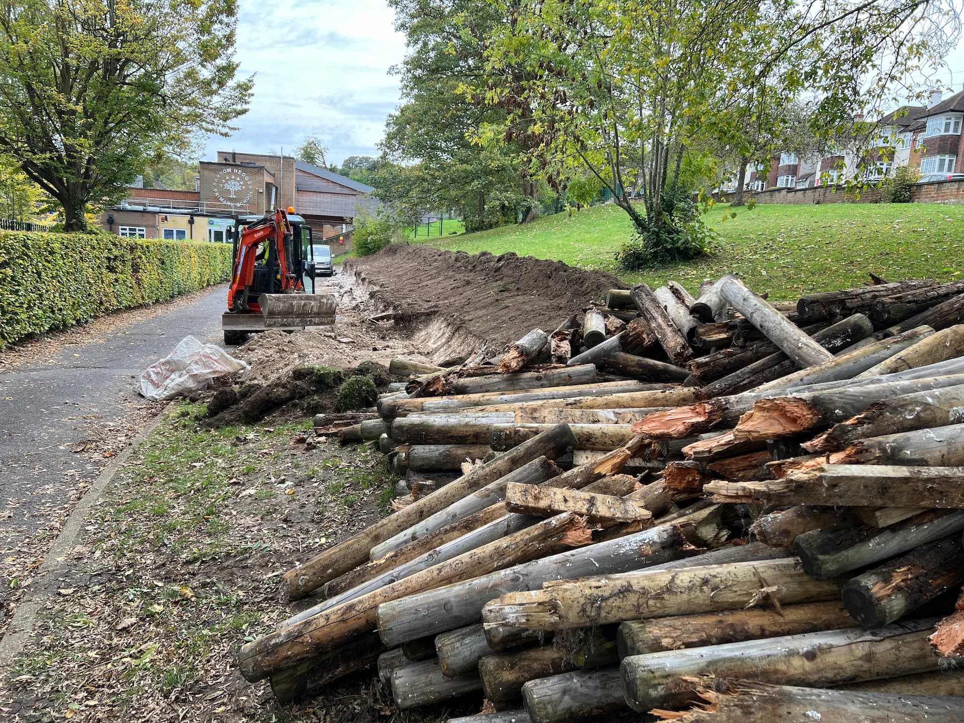Grass Barbers professional landscaping team performing site levelling and drainage installation in Surrey